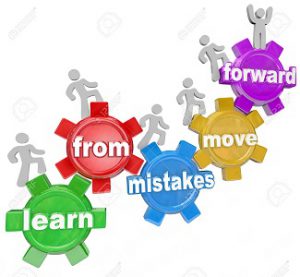 Learn From Mistakes Move Forward words on gears and people marching, climbing or walking up them to illustrate people who make errors but keep going toward their goal or mission